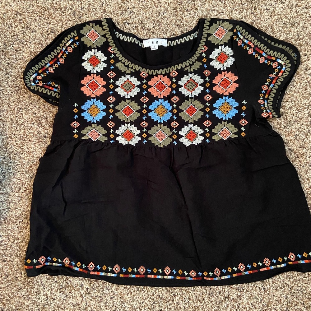 Black top with embroidered design